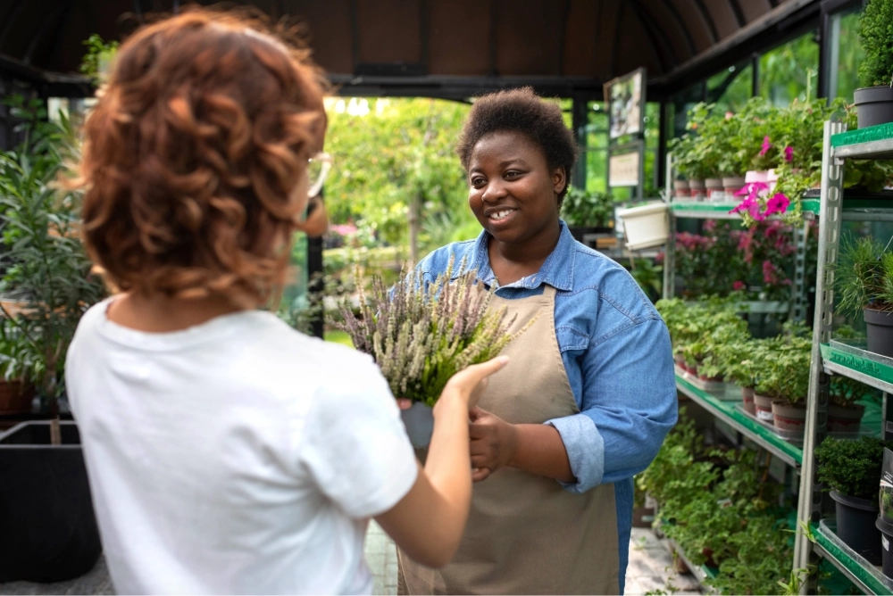 Woman flower seller with customer on shop